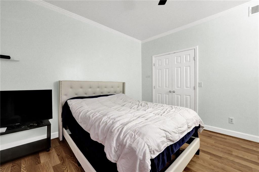 3825 Lavista Road, Unit O1 Tucker, GA 30084 - Photo 22 of 36 a bed sitting in a bedroom and a flat screen tv