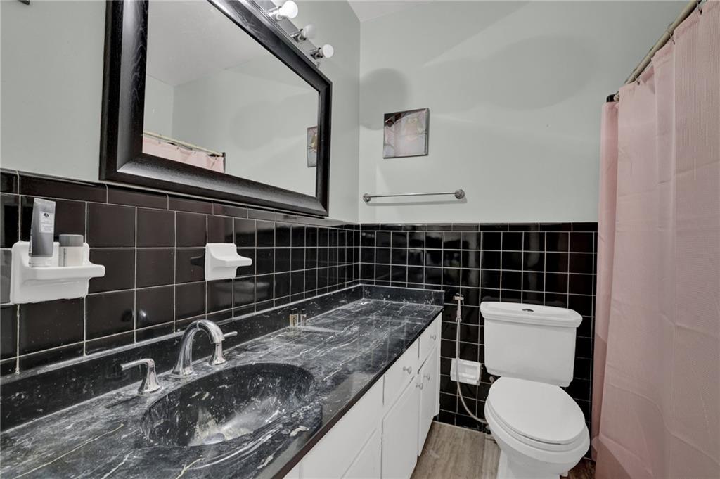 3825 Lavista Road, Unit O1 Tucker, GA 30084 - Photo 28 of 36 a bathroom with a granite countertop toilet sink and mirror
