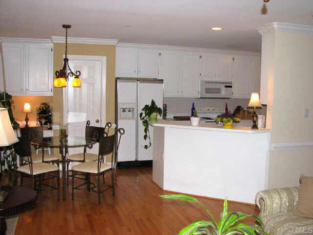 2017 Laurel Valley Way Raleigh, NC 27604 - Photo 10 of 10 a kitchen with stainless steel appliances granite countertop a refrigerator a microwave a stove and a dining table with wooden floor
