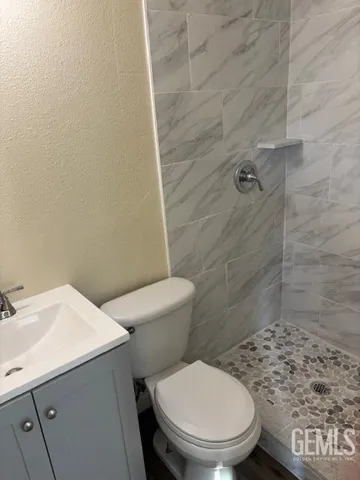 a white toilet sitting next to a bathroom sink