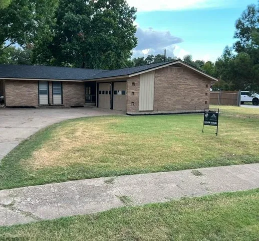 a backyard of a house with table and chairs