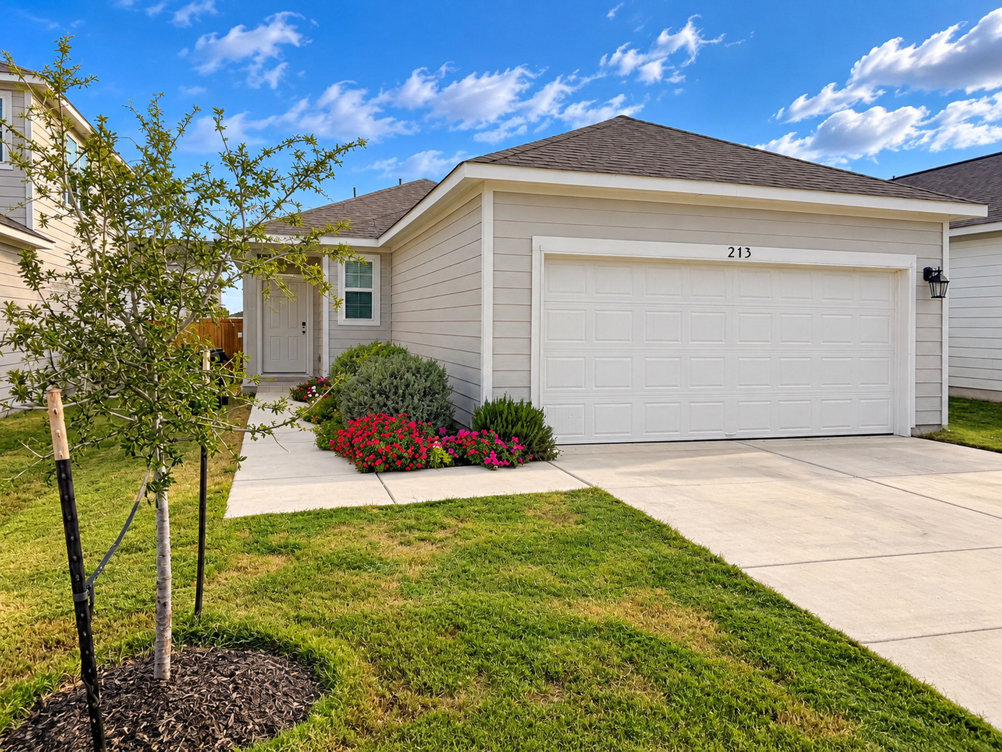213 Escape Way Jarrell, TX 76537 - Photo 15 of 15 An inviting front elevation pairs neat horizontal siding with a pristine concrete driveway and walkway.