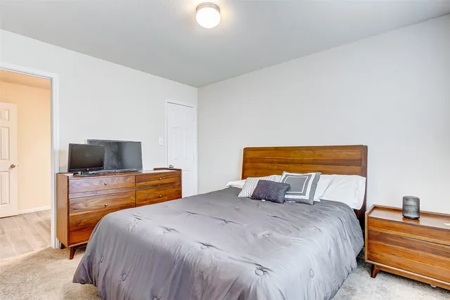 a bedroom with a bed and a television