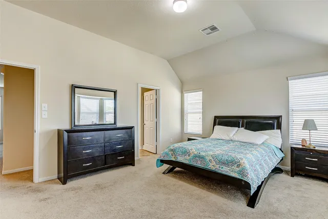 a bedroom with a bed and a dresser