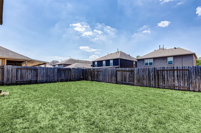 a view of a house with wooden fence