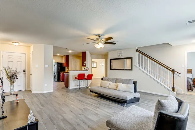 a living room with furniture and wooden floor