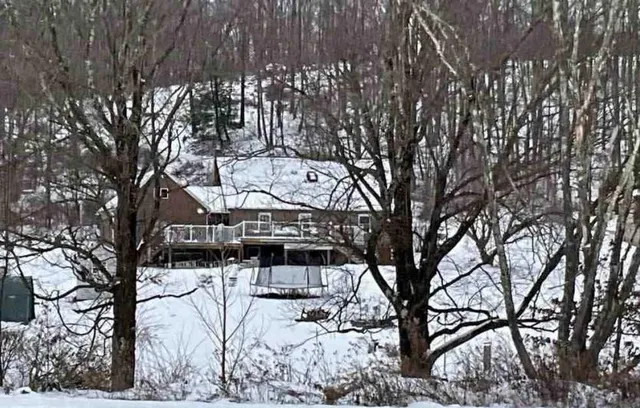 a view of a house with a snow in the yard