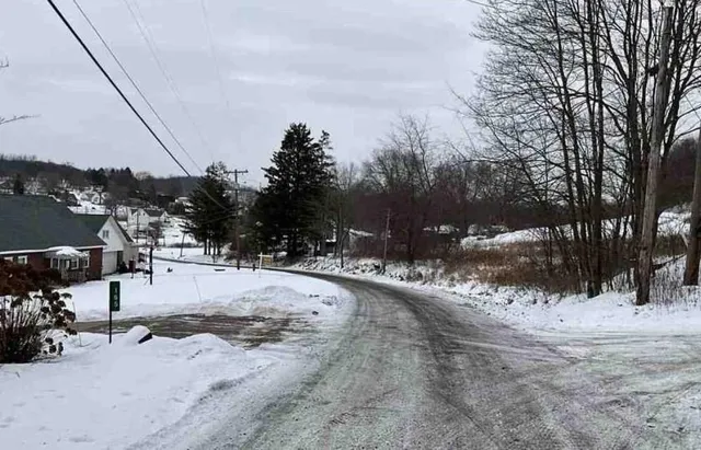 a view of snow on the side of road