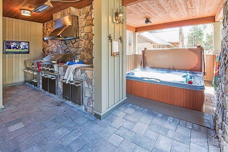 144 Sunstone Loop Bend, OR 97707 - Photo 9 of 24 Outdoor kitchen, patio and hot tub area