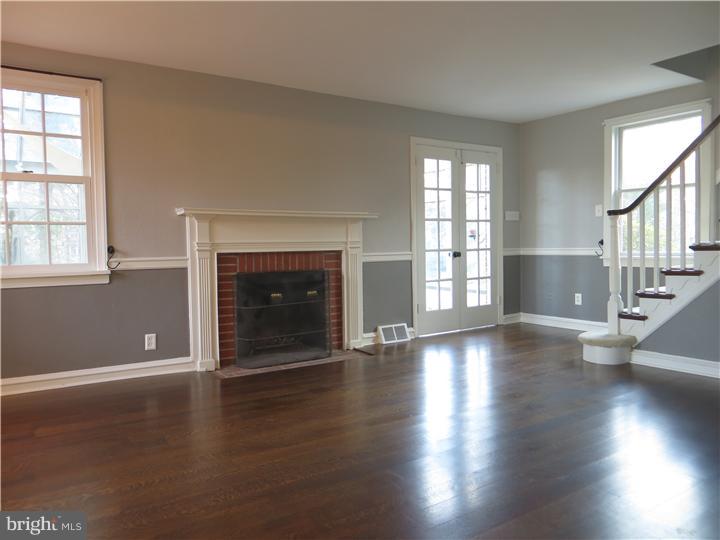 108 Grubb Road Malvern, PA 19355 - Photo 3 of 23 an empty room with windows and a fireplace