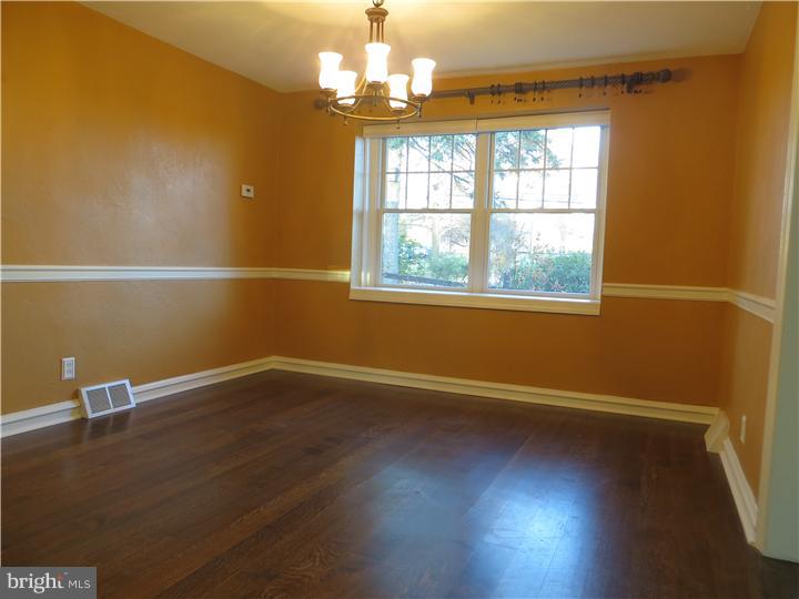 108 Grubb Road Malvern, PA 19355 - Photo 4 of 23 an empty room with wooden floor and windows