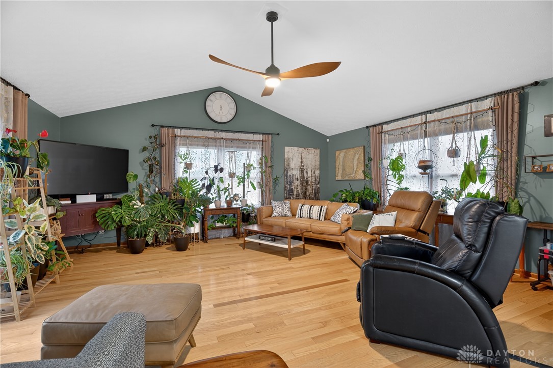 5264 Frazier-Guy Road Sidney, OH 45365 - Photo 18 of 51 This airy living room features high ceilings and hardwood floors, creating an inviting and bright atmosphere.
