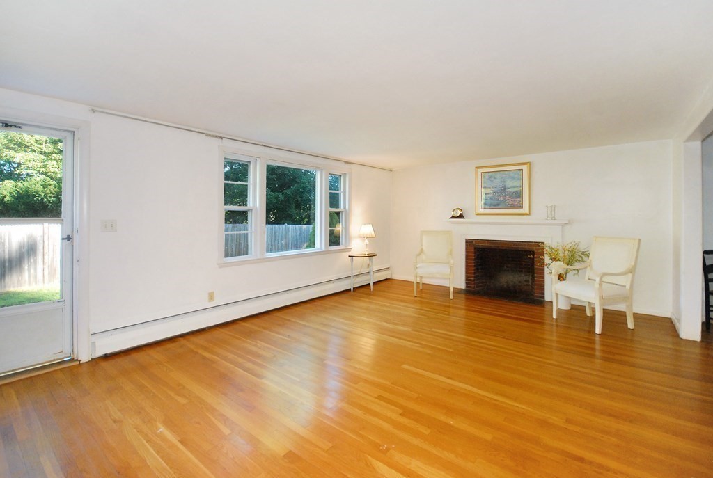 150 Lincoln Road Lincoln, MA 01773 - Photo 3 of 25 a view of empty room with wooden floor and fireplace