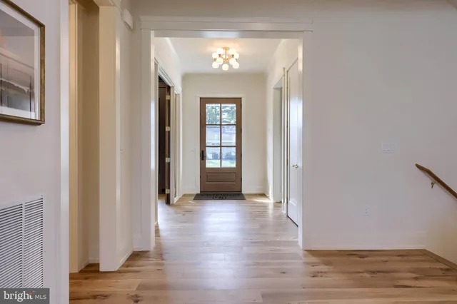 a large living room with fireplace furniture and a chandelier