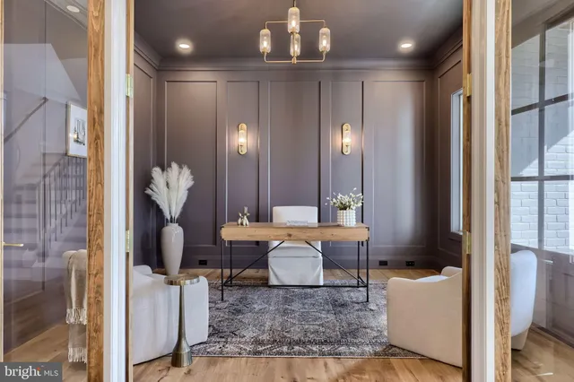 a living room with fireplace furniture and a chandelier