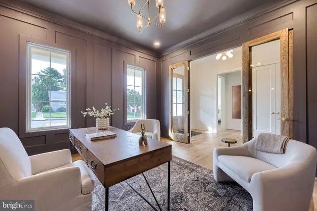 a living room with furniture potted plant and a chandelier