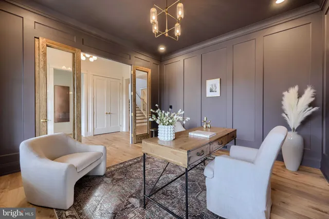 a kitchen with stainless steel appliances granite countertop a stove a sink refrigerator a dining table and chairs with wooden floor