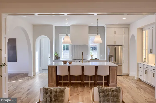 a large kitchen with a large counter top appliances and cabinets