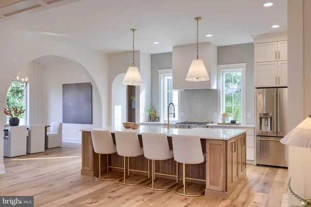 a kitchen with stainless steel appliances granite countertop a stove top oven a sink a counter space and cabinets