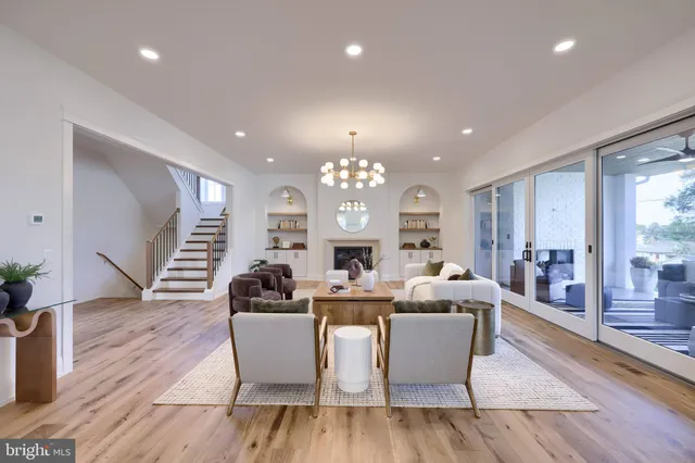 a living room with fireplace furniture and a large window