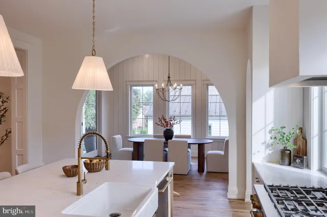 a view of a dining room with furniture a chandelier and wooden floor