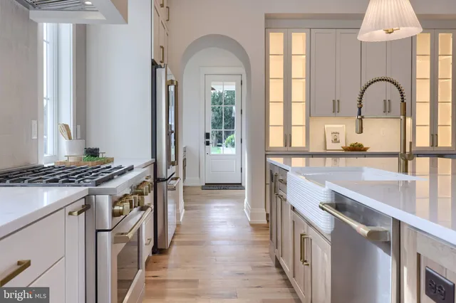 a spacious bedroom with a bed and wooden floor