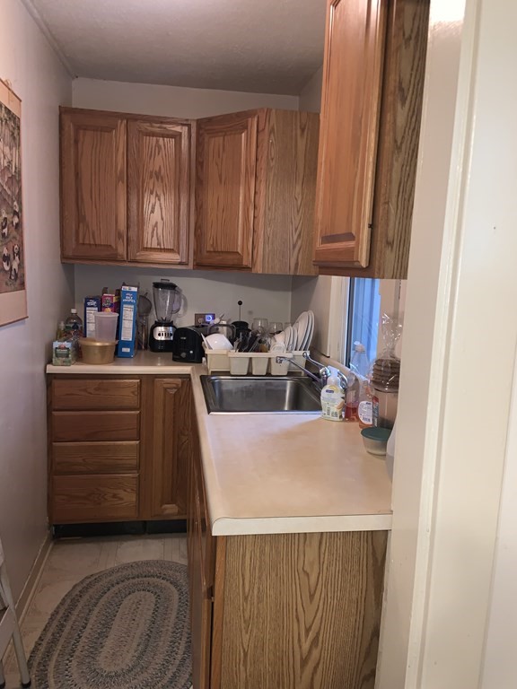 35 Barber Street Springfield, MA 01109 - Photo 4 of 13 a kitchen with a cabinets and appliances