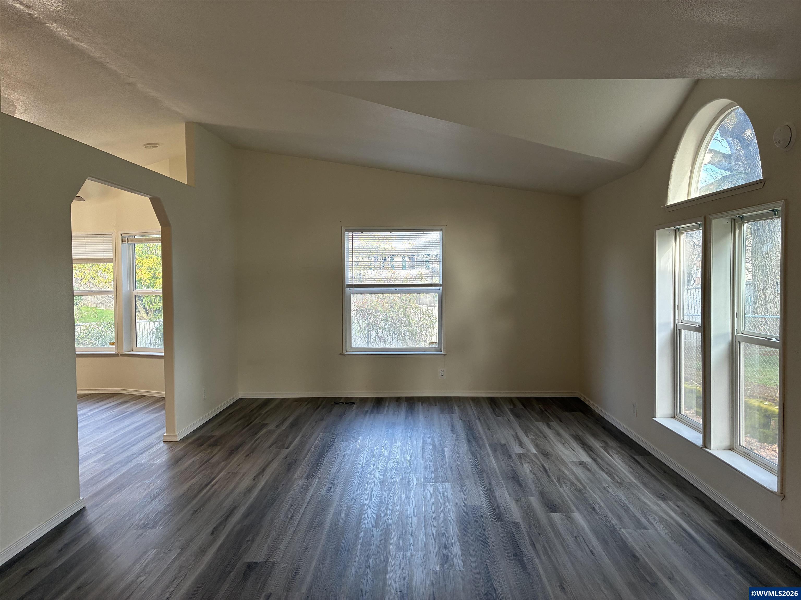 2000 Robins Lane Southeast, Unit 7 Salem, OR 97306 - Photo 4 of 39 a view of an empty room with wooden floor and a window