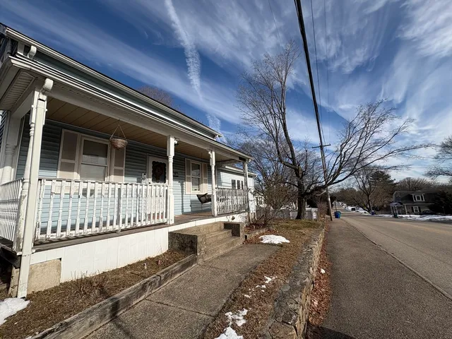 a view of a house with a large tree