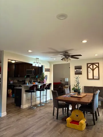 a view of a dining room with furniture and wooden floor