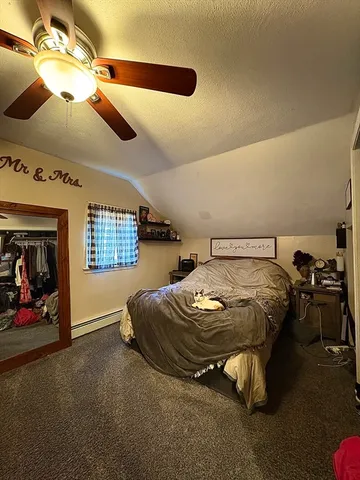 a spacious bedroom with a bed and a chandelier