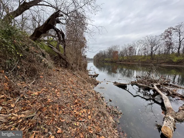 a view of a lake with houses in the back