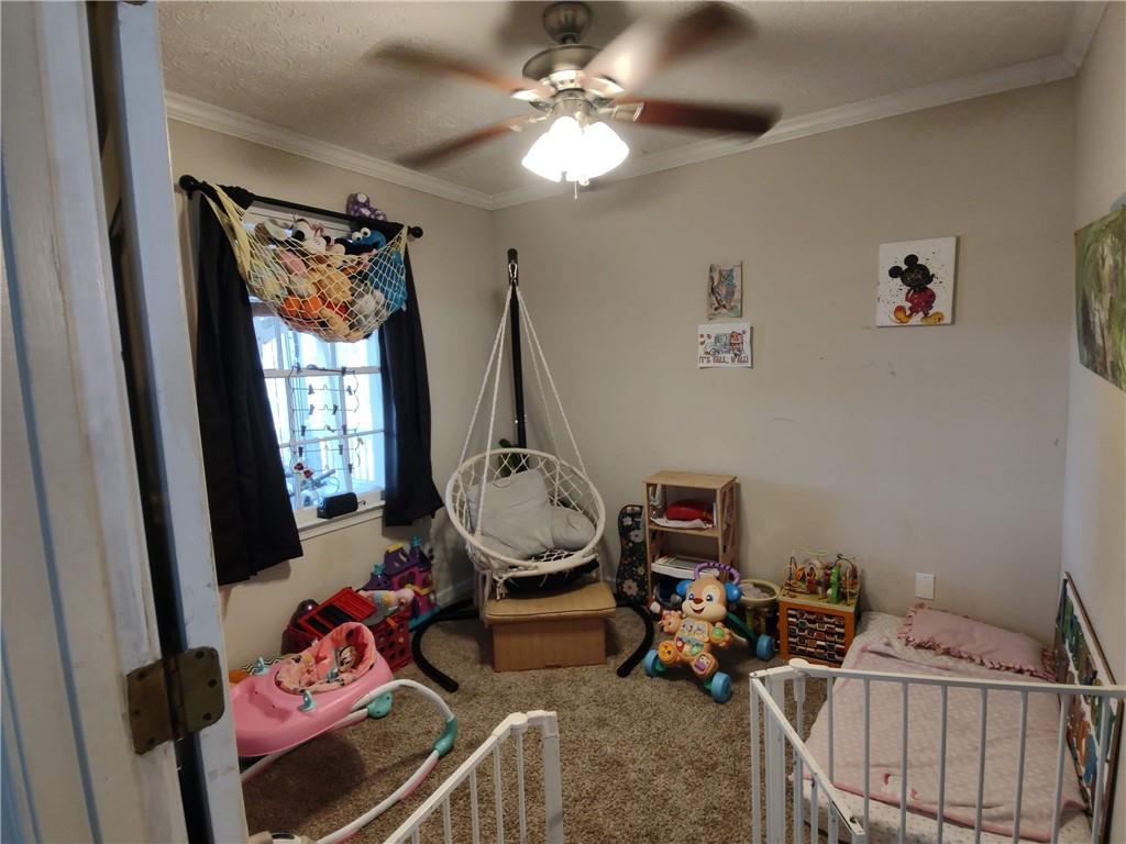 23 The Trail Southeast Lindale, GA 30147 - Photo 11 of 37 a bedroom with furniture and a window
