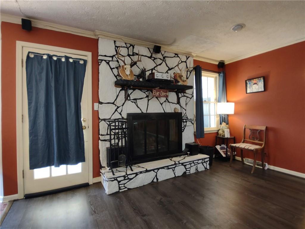 23 The Trail Southeast Lindale, GA 30147 - Photo 16 of 37 a living room with furniture a fireplace and wooden floor