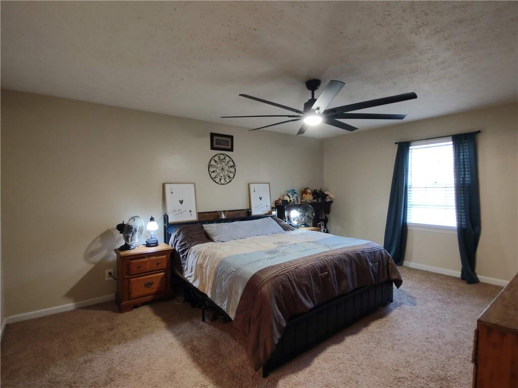 23 The Trail Southeast Lindale, GA 30147 - Photo 21 of 37 a bedroom with a bed and window