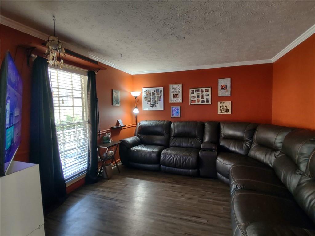 23 The Trail Southeast Lindale, GA 30147 - Photo 4 of 37 a projector room with a couch wooden floor and a window