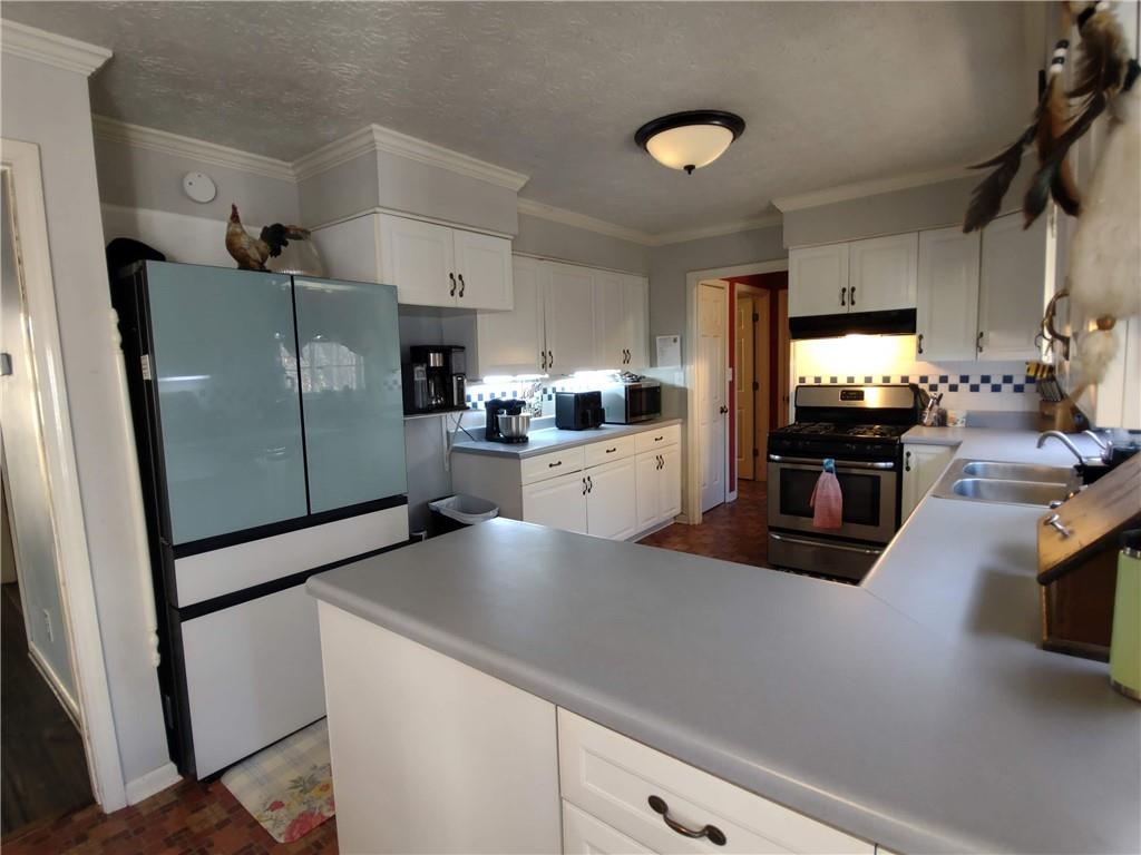 23 The Trail Southeast Lindale, GA 30147 - Photo 5 of 37 a kitchen with granite countertop a refrigerator and a sink