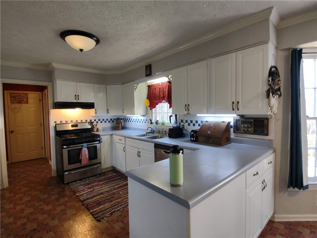 23 The Trail Southeast Lindale, GA 30147 - Photo 6 of 37 a kitchen with granite countertop a sink cabinets and stainless steel appliances