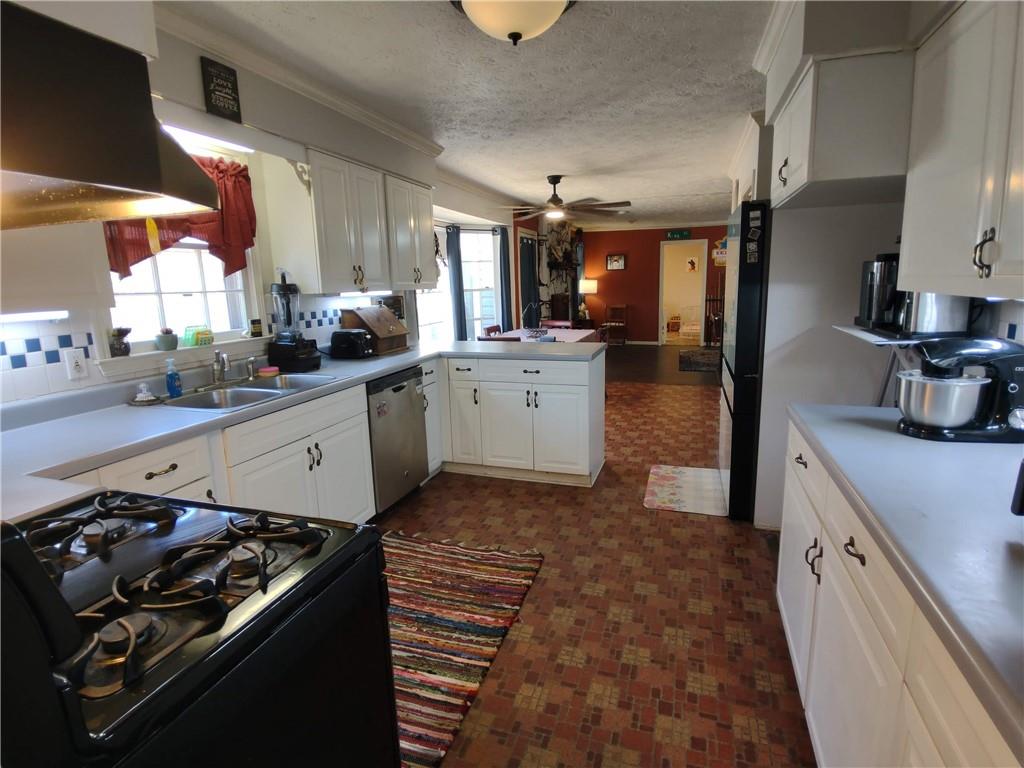 23 The Trail Southeast Lindale, GA 30147 - Photo 7 of 37 a kitchen with a sink stove and cabinets