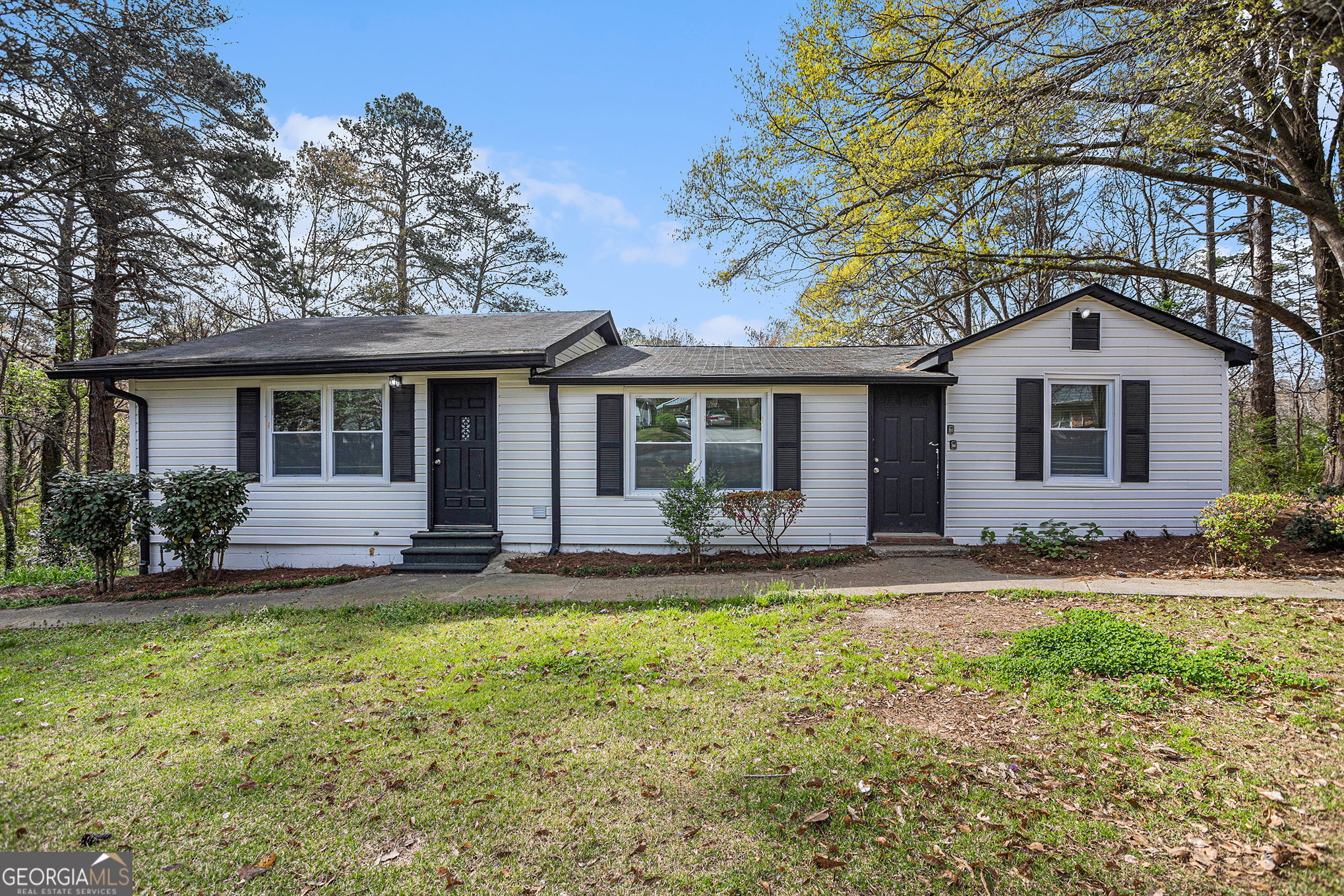 a front view of a house with a yard and porch