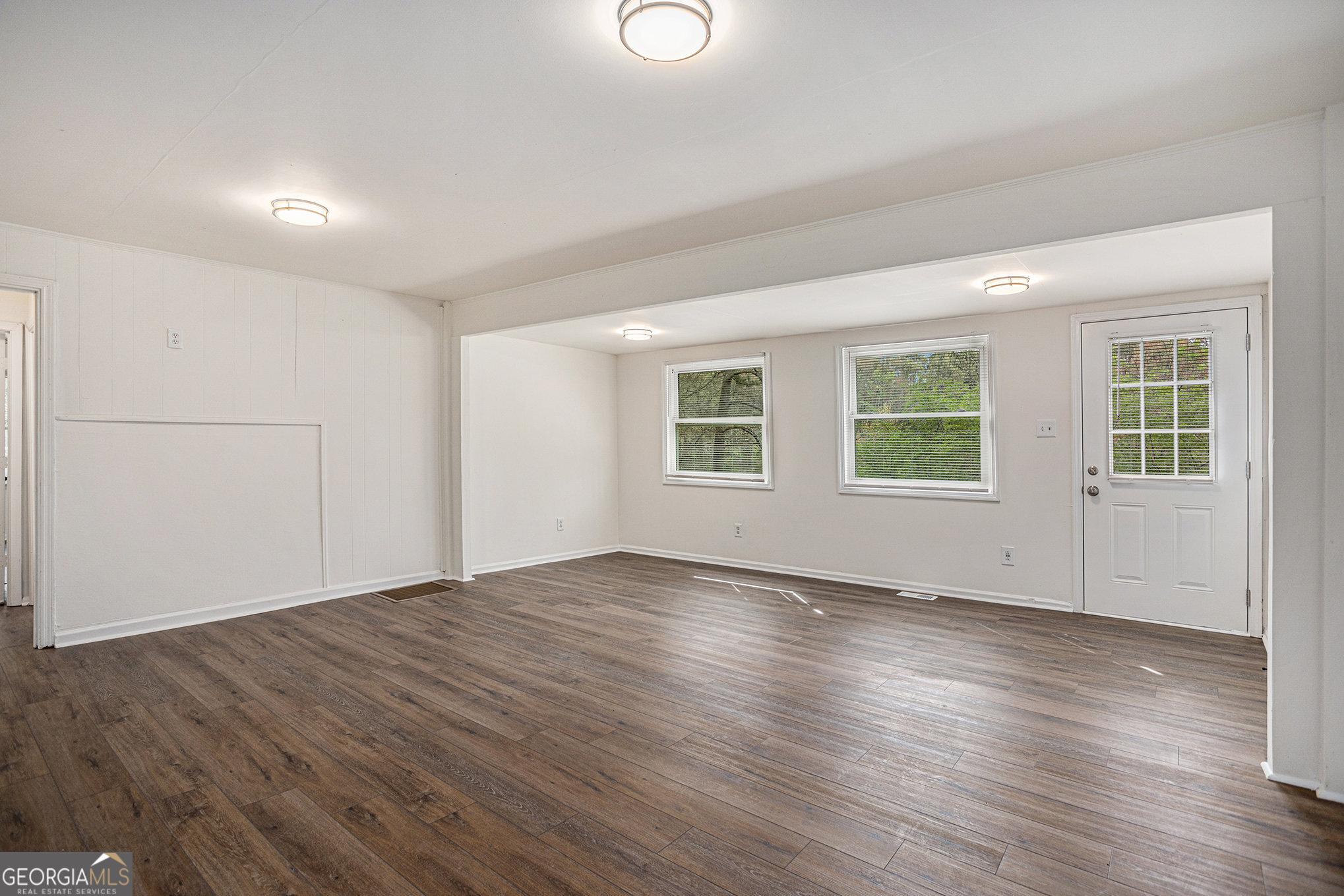 1113 Lake View Drive Jonesboro, GA 30236 - Photo 11 of 25 an empty room with wooden floor and windows
