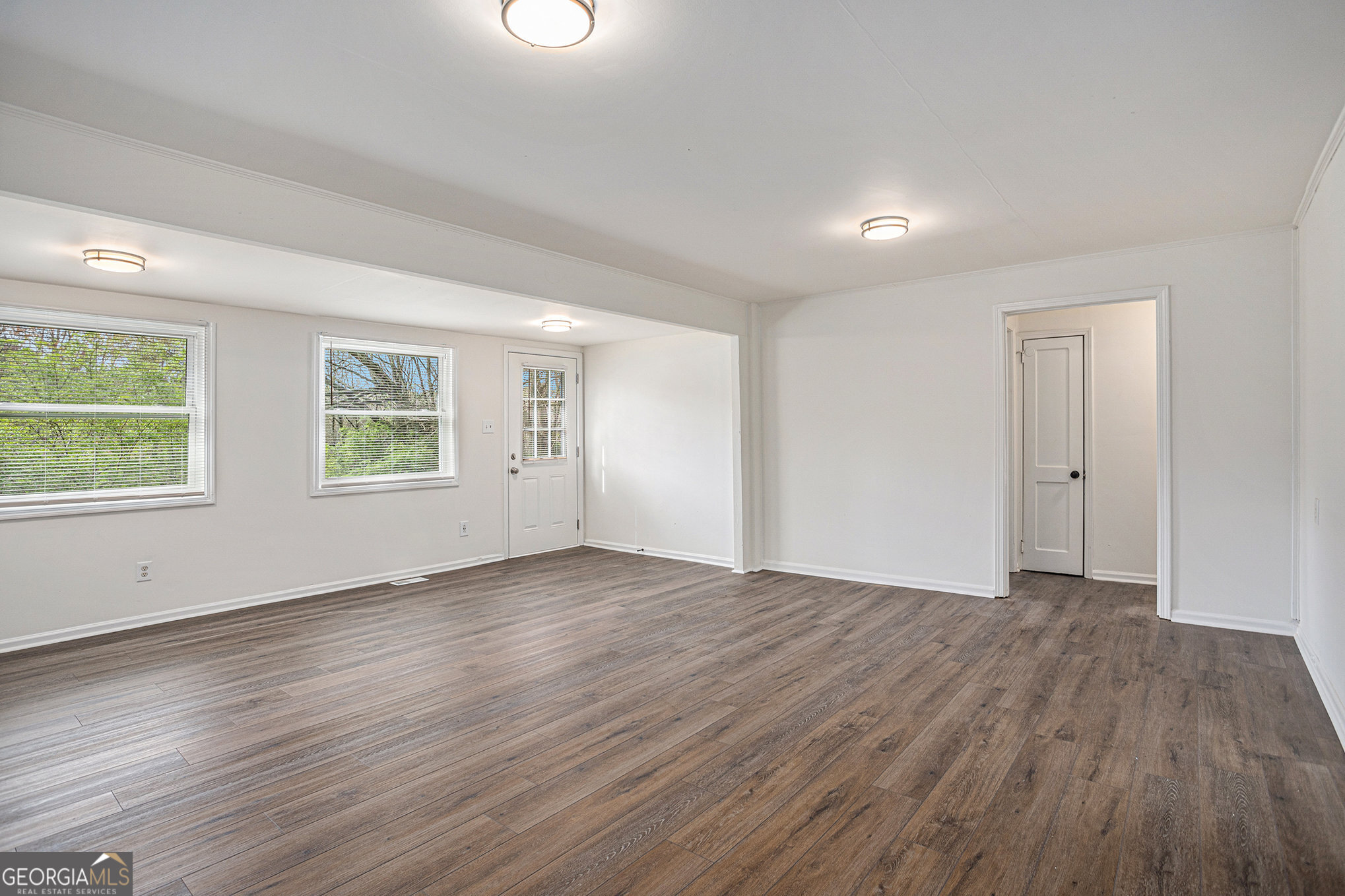 1113 Lake View Drive Jonesboro, GA 30236 - Photo 12 of 25 an empty room with wooden floor and windows