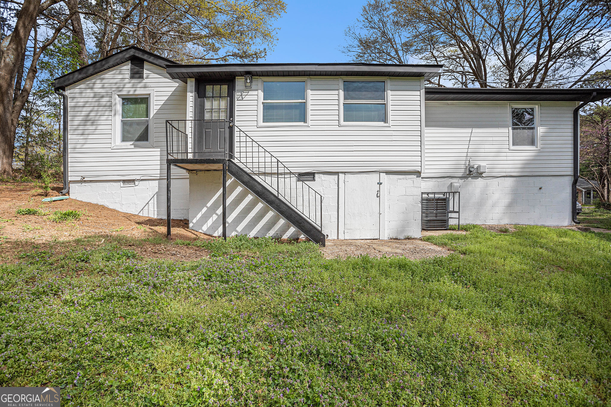 1113 Lake View Drive Jonesboro, GA 30236 - Photo 22 of 25 a view of backyard of house with wooden deck and seating