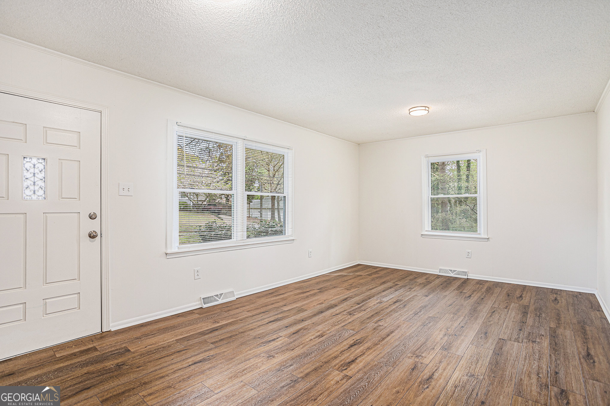 1113 Lake View Drive Jonesboro, GA 30236 - Photo 4 of 25 a view of an empty room with wooden floor and a window