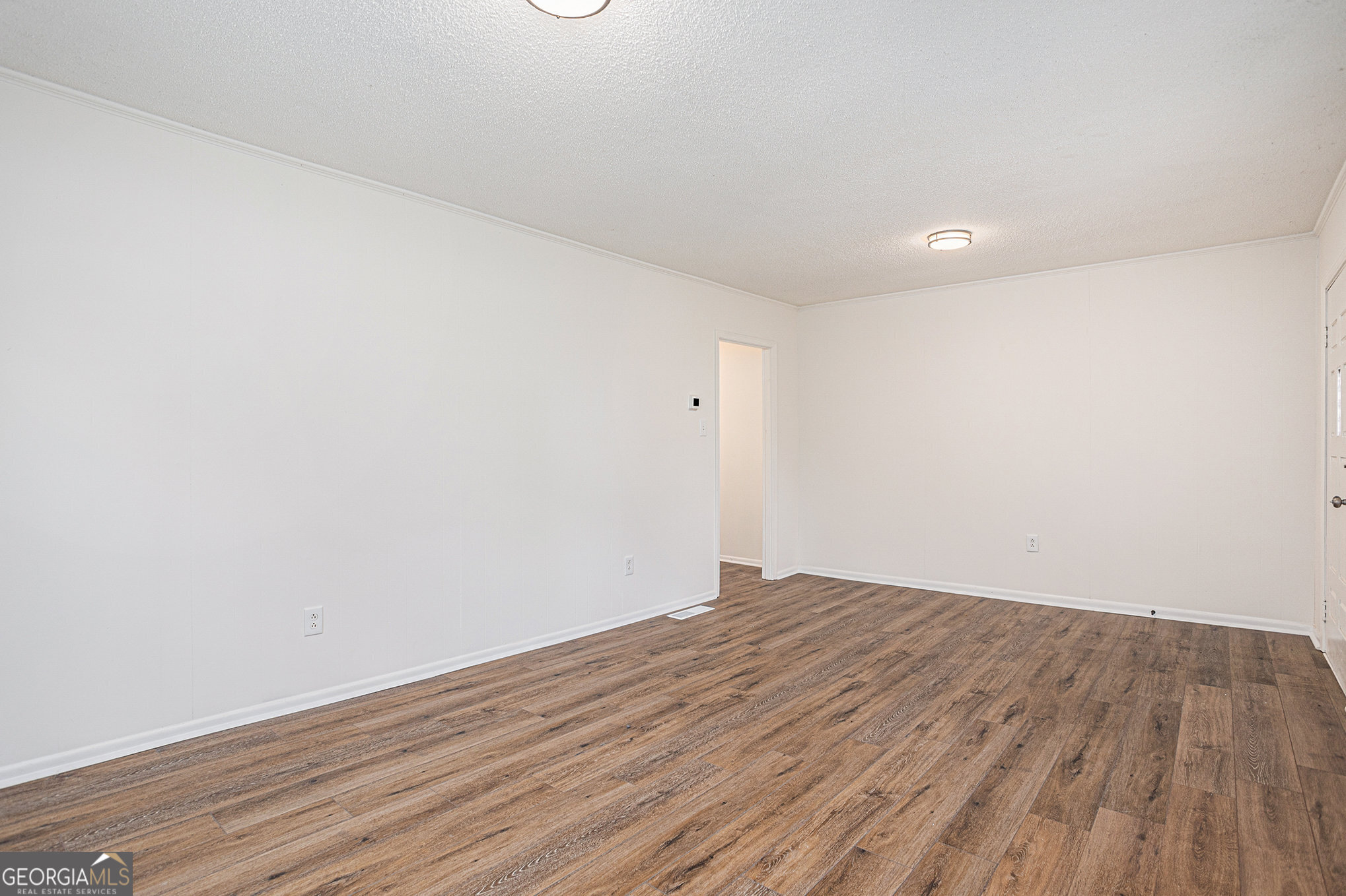 1113 Lake View Drive Jonesboro, GA 30236 - Photo 5 of 25 a view of an empty room with wooden floor