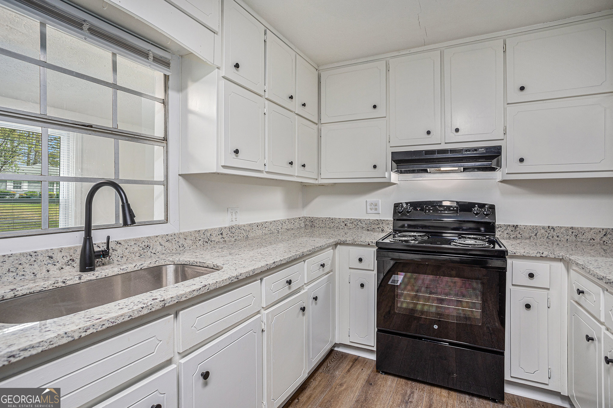 1113 Lake View Drive Jonesboro, GA 30236 - Photo 6 of 25 a kitchen with granite countertop white cabinets and stainless steel appliances
