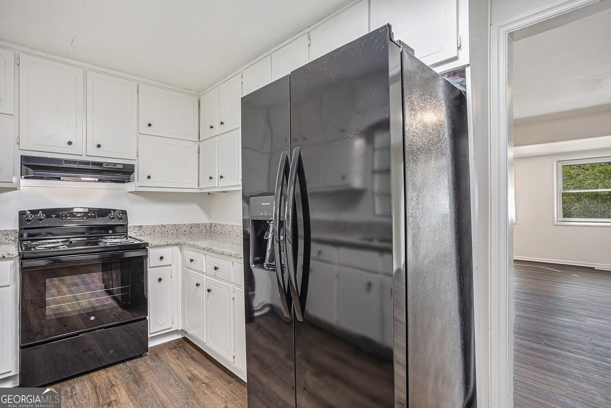 1113 Lake View Drive Jonesboro, GA 30236 - Photo 7 of 25 a kitchen with stainless steel appliances granite countertop a refrigerator a stove and a sink with wooden floor