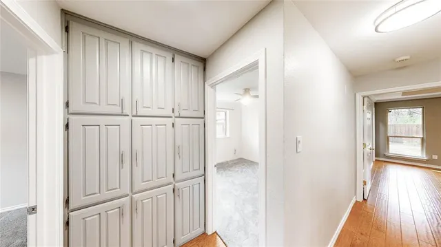 a view of a hallway with wooden floor
