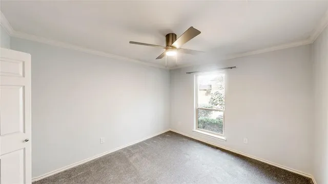 a view of empty room with ceiling fan
