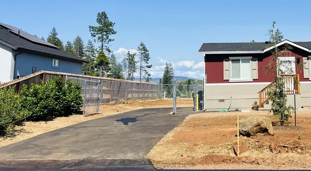 a view of a house with a backyard